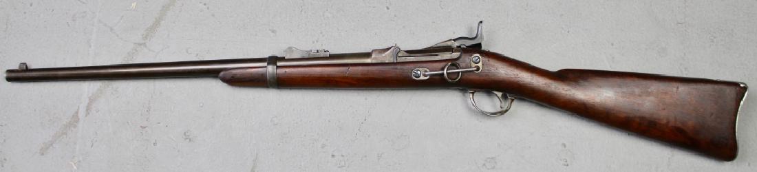 US Springfield Trapdoor Carbine Model 1873: 45/70, manufactured 1883, serial # 228460, 22" barrel, adjustable height rear sight, saddle ring, normal condition issues which are very minimal.
