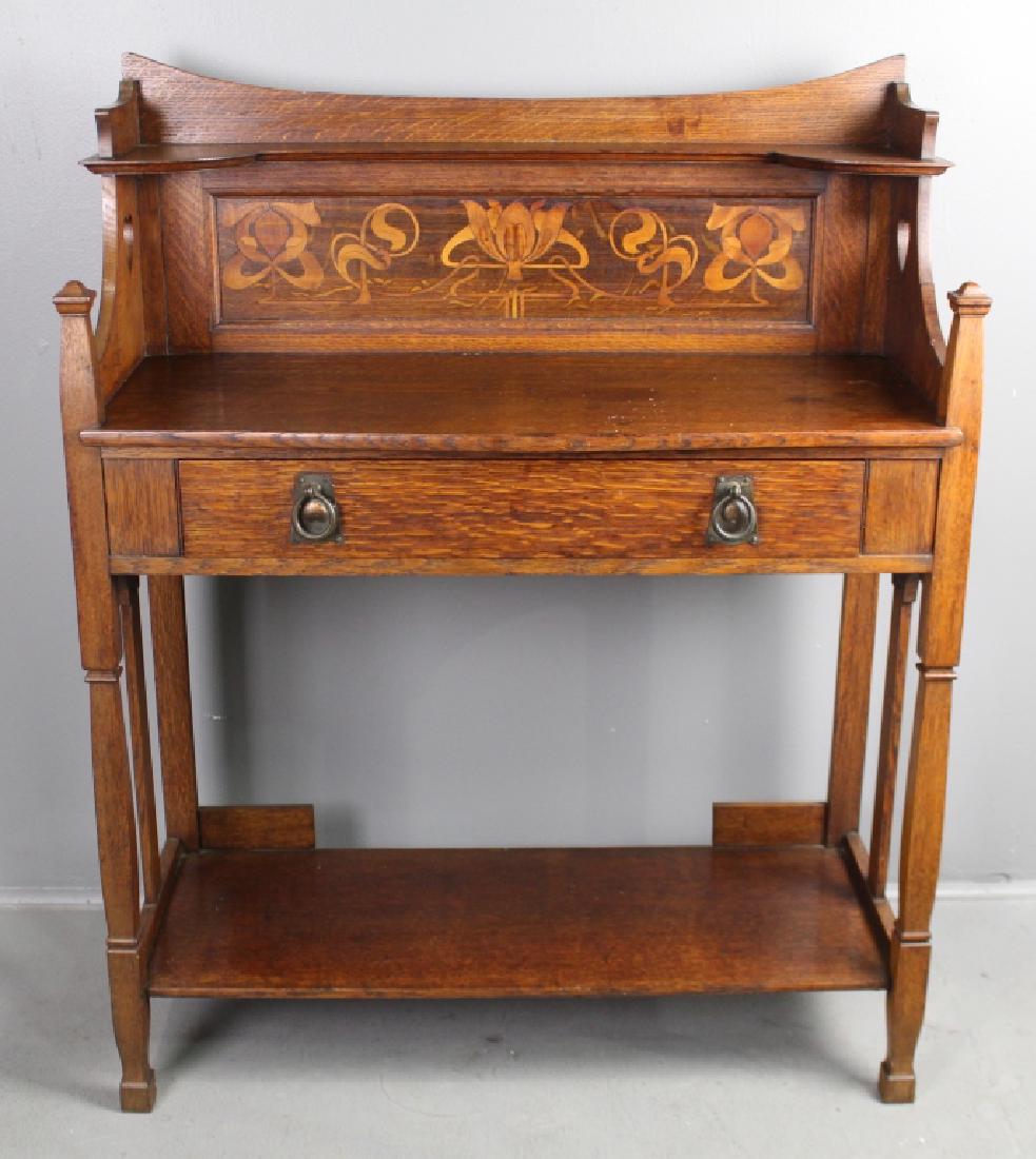 English Arts & Crafts Oak Washstand: with elaborate mixed wood marquetry inlaid back-splash single drawer with original ring pull hardware,overhang top with candle shelf, heart cut-out sides, turned square shaped legs, lower shelf, this 