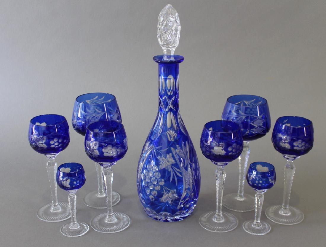 Cobalt Cut-to-Clear Decanter Set with 8 Stems: 7 large 8" stems, 8-7" stems and 9-4.75" stems, 14.5" decanter, all in good condition.