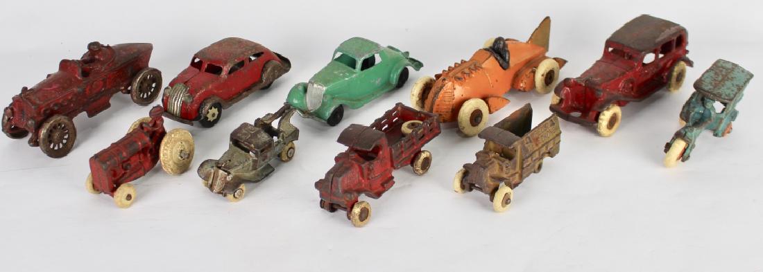 10 Vintage Toy Cars and Trucks: Hubley race car, red race cars with metal wheels, 4-door cast iron sedan with rubber wheels, friction red sedan, Hubley green coupe, cast iron "Flowers" motor trike missing rubber wheel, Arcade red tr
