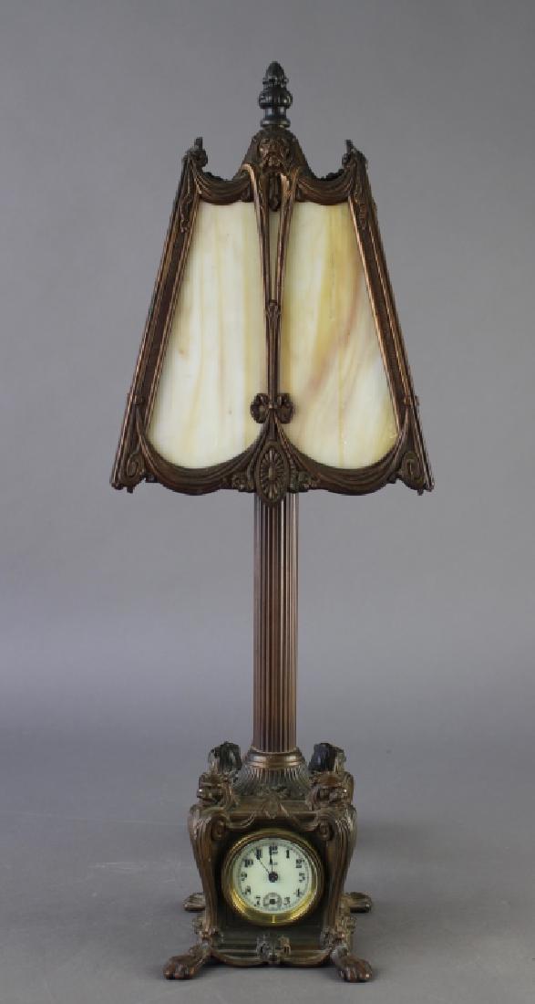 Unusual Slag Panel Lamp with Clock: combination, clock base features a porcelain face and second hand movement, lion's head corners and two feet, lamp is 4-panel with equally impressive lion head on it's frame, 20" x 7" square, all work