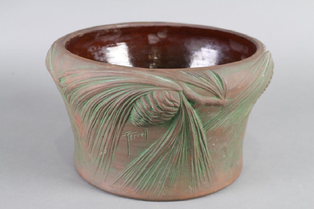 Peters and Reed Jardiniere Moss Aztec: with pinecones and needles, 7" x 12", signed Frank Ferrell, unusual Roseville shield paper label on bottom that appears to be original to the piece (go figure) very good condition.