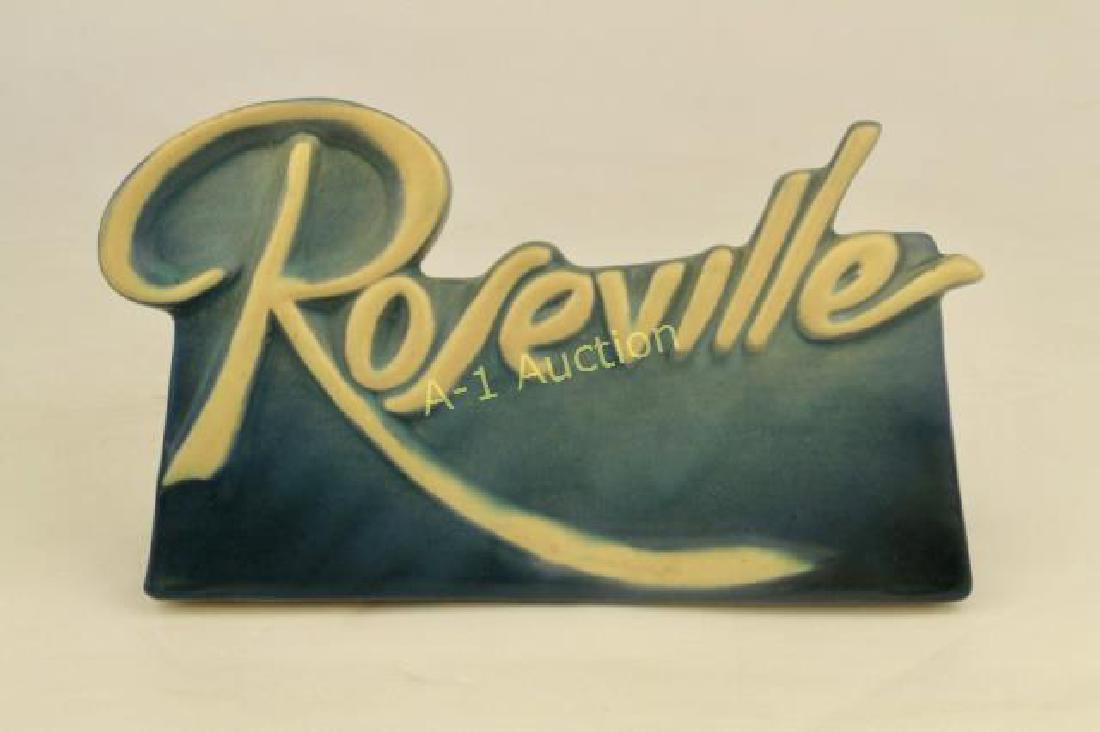 Large Roseville Dealer Sign: c. 1940s, Roseville in raised cream color lettering on blue mat background, 8" x 4.5", excellent original condition, flawless.