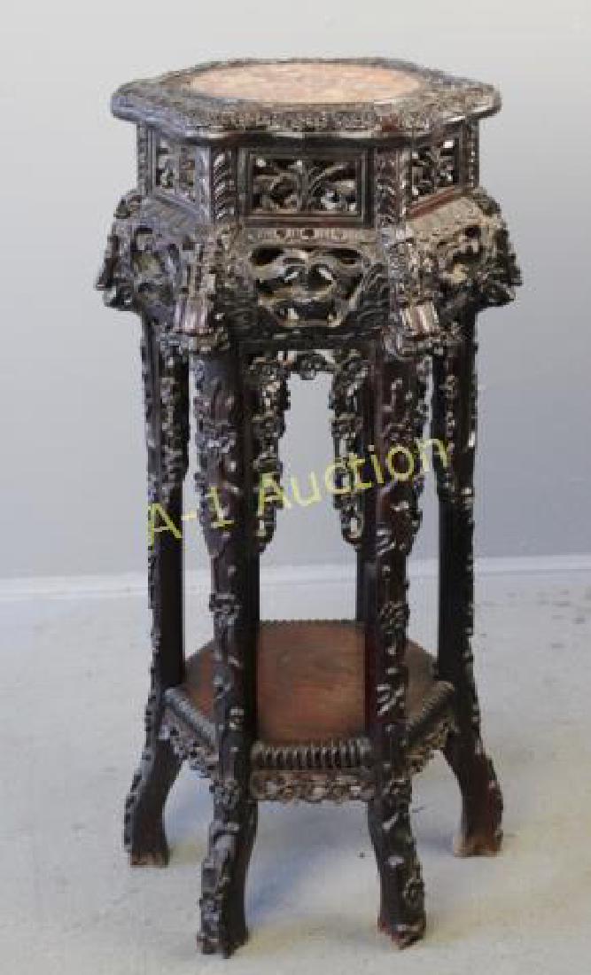 Asian Carved Hardwood Stand: with marble inset top, hexagon shape with carving on every possible surface. Late 19th century, good condition with small piece missing on top. 32" x 15" diameter.