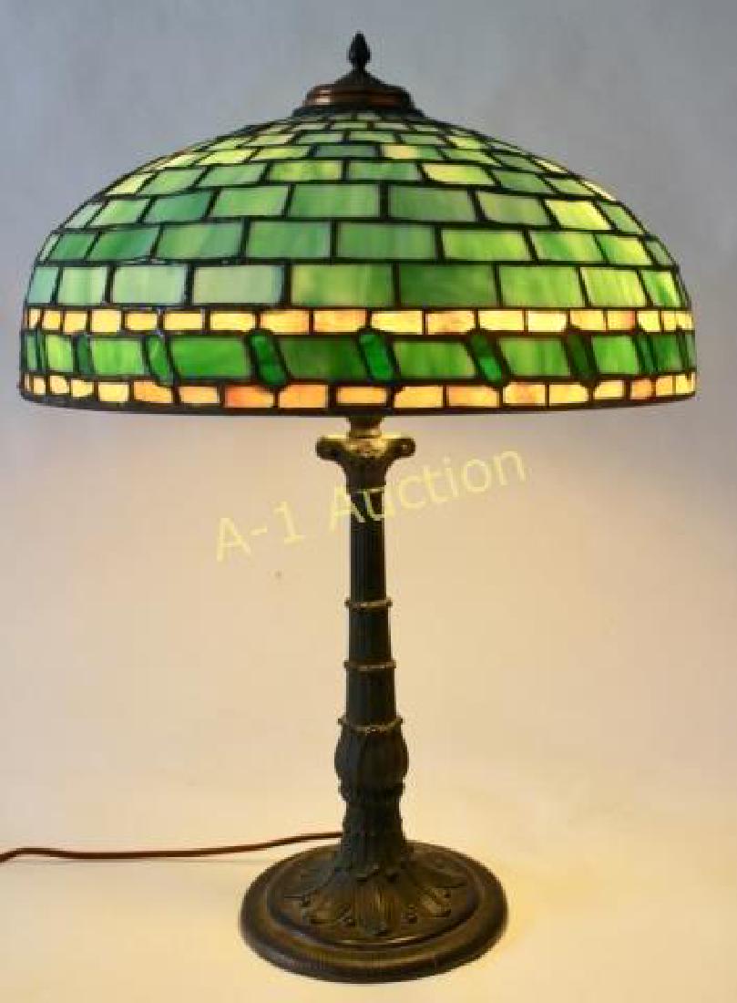 Duffner & Kimberly Table Lamp: #504 Duffner bronze base, leaded geometric dome with repeating border, shade by Wilkinson, new silk wiring, 3 socket housings replaced, chains are old, restoration to some glass tiles, 18.5" diameter,