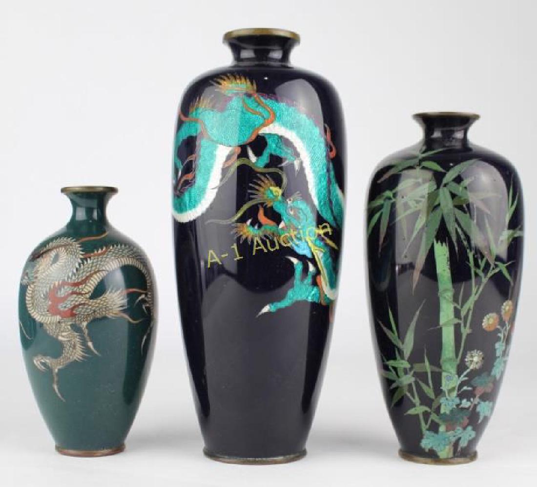 Three Japanese Cloisonne Vases: an incredibly detailed green dragon on 7" cobalt vase, equally nice bamboo and florals on 6" cobalt vase and a dragon on a 4.5" green enameled vase, all in good condition.
