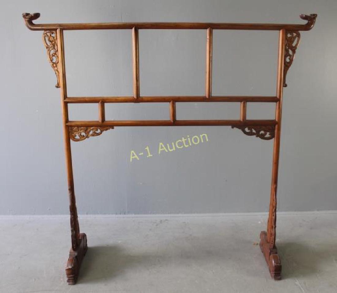 Chinese Carved Hardwood Garment Rack: tenon joinery, stylized dragon heads, pierced carved supports for feet, 60"h x 63"w x 20"d, good sturdy condition.