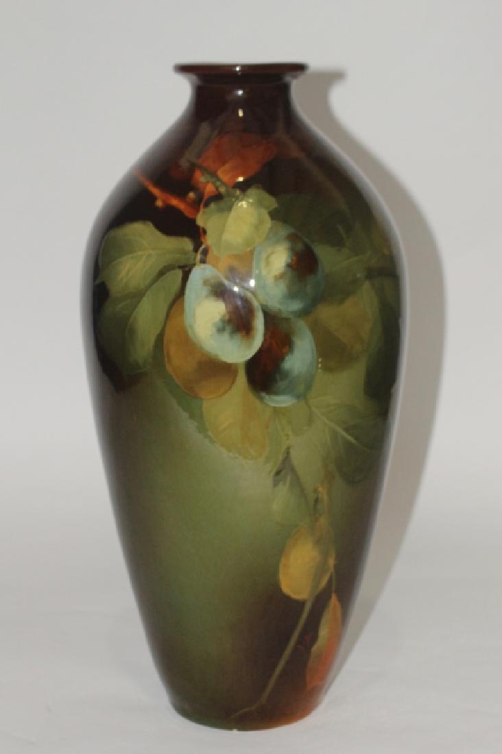 Weller Louwelsa Standard Glaze Vase: artist decorated pears, leaves, limbs, signed Frank Ferrell (initials), half kiln impressed mark, excellent condition, (black lighted), very very minor crazing, 18.5" tall.