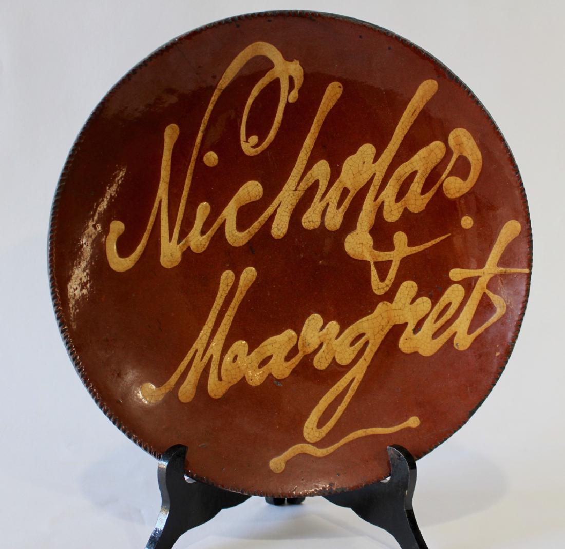 Slip Decorated Redware Plate: extremely rare, inscribed "Nicholas & Margaret" probable Norwalk, CT. origin, c. 1840, desirable decorative script of names featuring loops and embellishments, some roughness to thumbnail pressed edge