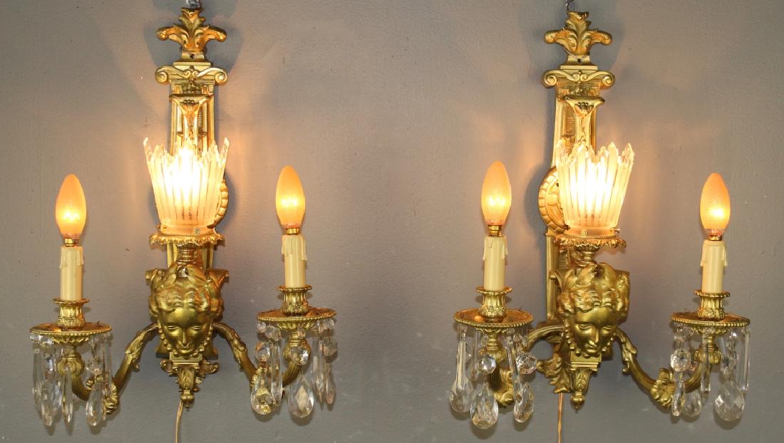 Pair of French Gold Gilt Bronze Sconces: 3-light, each with two candelabras with dripping prisms, then a centered light with frosted rayed shade, classical woman's face, fleur-de-lis bracket design, heavy, 22" tall x 15" w x 9" deep, re-wire