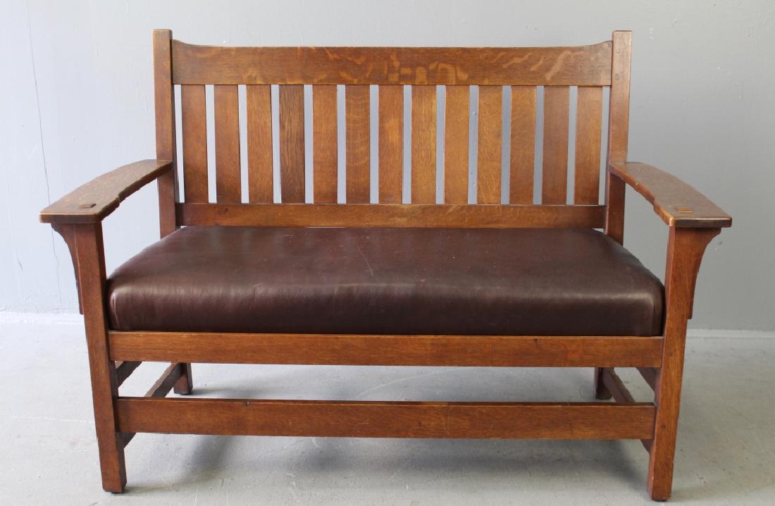 L. & J. G. Stickley Arts and Crafts Settee: drop arm style, #225, refreshed finish to our knowledge, drop-in spring seat cushion with new leather, 36.5" x 45" w x 20.5" deep. Very good condition, signed with yellow decal.