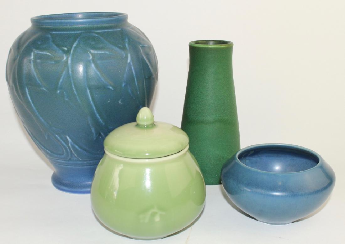 Four Rookwood Pottery Pieces: fine blue mat glaze 8.5" bulbous vase, #2220, 1922 with raised calligraphy decoration, small blue mat bowl #955, 1920 and early thick green lava mat glaze, 7" #950E, 1905 and a 1945 celadon high glaze