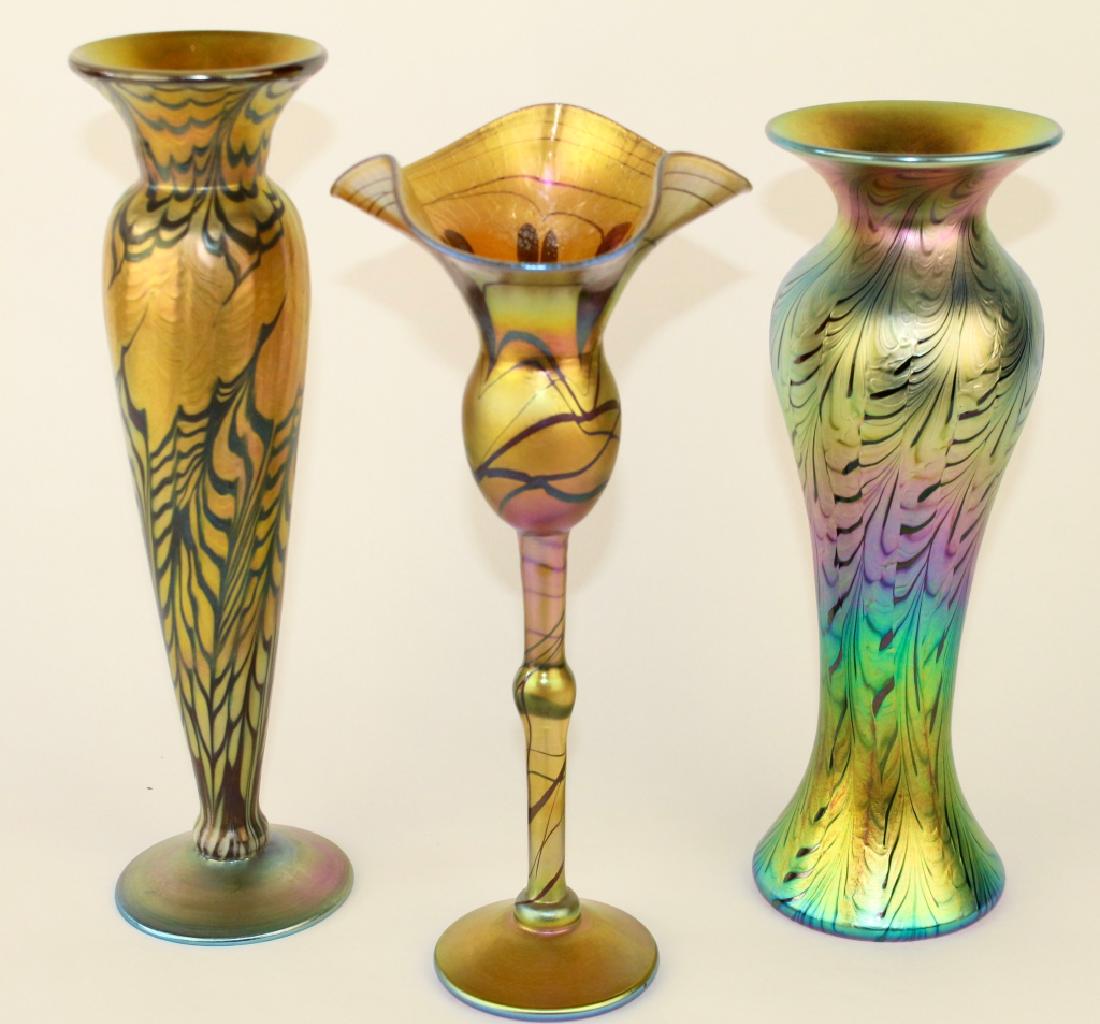 Three Lundberg Studios Art Glass Vases: 12" floraform hearts and vines stemmed vase with stretched gold iridescent open top, a 12" Rainbow Splash figure" vase with stunning iridescent colors, dated 2009, and a 12.5" , 2009 vase with Durand-