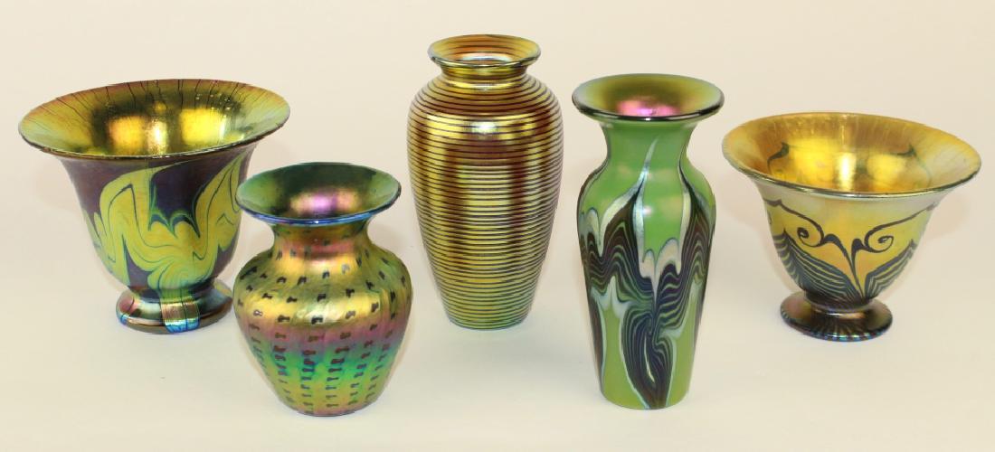 Five Lundberg Studios Art Glass: cabinet vases: a 3.75" x 4.75" flared pedestal cobalt vase, a 2000 3.5" spotted gold iridescent vase, a 5" gold vase with horizontal ribbing, 2004, a 3" x 4.25" flared pedestal bowl with pulled feathe