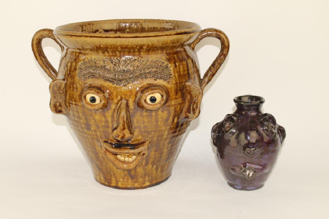Two North Carolina Folk Art Face Jugs: a large open top flower pot with ear handles, 10" x 13", alkaline brown drip glaze, done and signed by Richard Kale and an "ugly face jug" from Bolick Pottery, Seagrove, NC. This 6" piece has a deep p