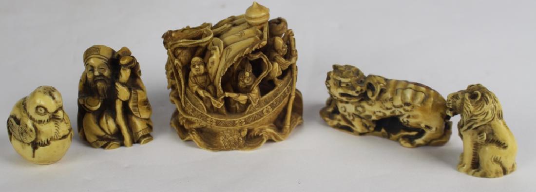 Japanese Netsukes, Group of Five: profusely carved depiction of men in sailboat, 2" x 2.5", red seal mark; Foo dog, 2.5" artist signed; chick hatching from egg, 1.5", signed; 1.75" kneeling street beggar; 1.5" sitting lion, all appear