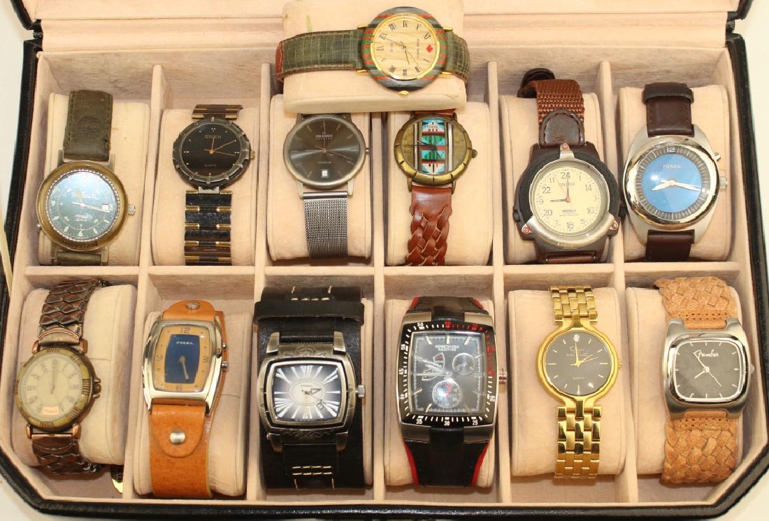 Group of 13 Men's Fashion Watches: in locking leather case included. Watches include Gruen, Kenneth Cole chronometer, Nautica, Fossil, Oscar De La Renta, Fender, Wood Watch, Skagen and Timberland, all in good condition, need batteries.