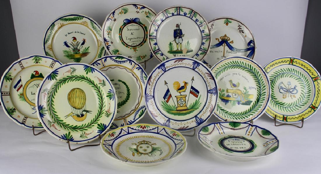 Twelve HB Quimper Plates: hand painted, 9.5", assorted and unusual, some with minor edge chips, one with 3" hairline, each signed.