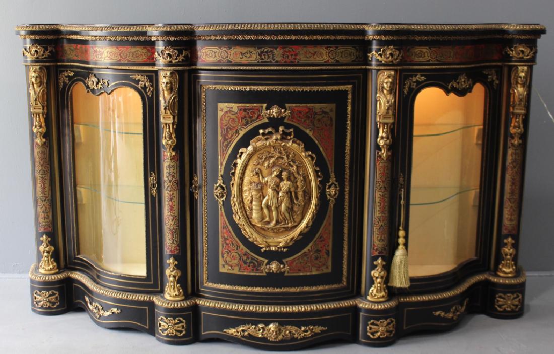 Continental Boulle Ebonized Credenza: generous amount of ormolu on doors, trim, edges, etc, serpentine glass door sides with glass shelves, interior lighting, 45" x 79" x 20.5, very good condition, a real show piece.