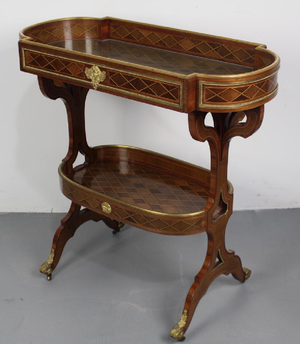Inlay Two-Tier Serving Table: continental style with parquetry inlay, tray top with glass bottom, tray second tier, brass ormolu trim, open work design on legs, minor veneer warping under glass in one quarter area, 30" x 30" x 14"