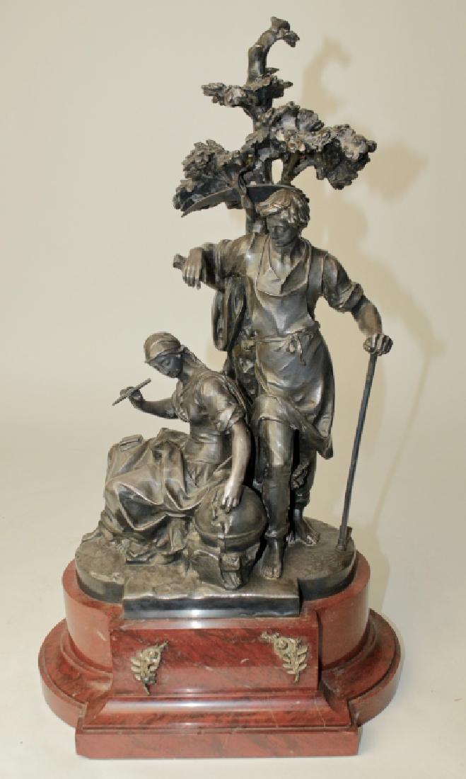 Christofle & Cie, Bronze Double Figure: ,Paris, patinated silver wash, depicts young couple, man with hoe and sling blade over looking seated girl with writing instrument placing something in an orb, signed/stamped on base above rouge marbl