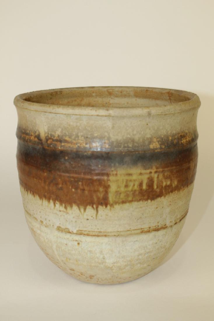 Toshiko Takaezu, Pottery Vase: 1922-2011, American, large hand thrown pot, earth tone glaze with band of two color browns encircling body, 9" x 9" diameter, signed "TT" on bottom, good condition. From Gainesville, Fl. estate.