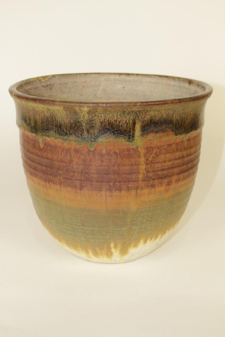 Toshiko Takaezu, Large Pottery Vase: 1922-2011, American, large hand thrown pot, multi colored earth tone glazes encircling, 8.5" x 9.5" diameter, signed "TT" on bottom, good condition.