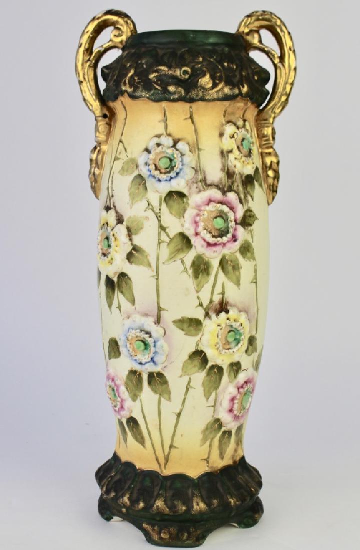 Amphora Porcelain Vase: made in Austria, decorated with white trailing roses on thorny stems, 16", gold handles, organic style top and bottom, signed, good condition.