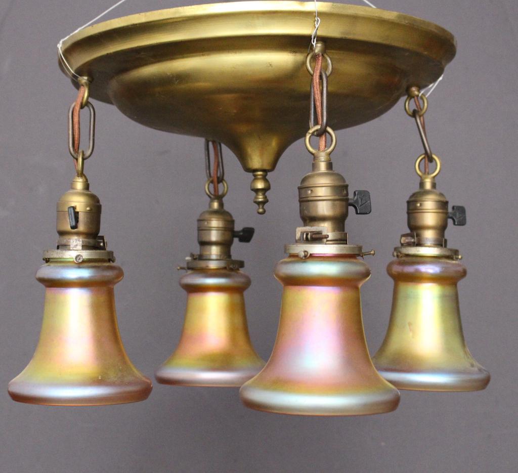 Chandelier with Steuben Shades: four lights, with Aurene shades, each signed with acid etched fleur-de-lis mark, all in very good condition, flush ceiling brass fixture, 17" diameter, 12" drop.