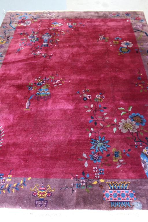 Chinese Nichols Rug 11.4' x 8.10': deep burgundy background with purple border, rich deep pile, fringe ends in very good condition, one area repairable moth damage, otherwise good condition.