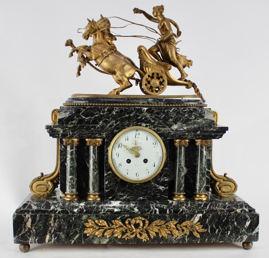 Outstanding French Marble Case Clock: special with bronze figural mythological chariot racer, 2-horse drawn, that sits atop the case, white veined black marble with 4 columns, bronze ormolu attachments, Japy Freres movement, porcelain ena