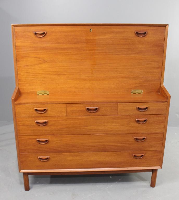 Danish Teak Mid-Century Drop Front Secretary: attributed to Skodborg Mobel Fabrik, evidence of labels on back now missing, drop down writing surface with fitted interior, 3 small drawers over 3 drawers in base, eyebrow pulls, good condition. Purc