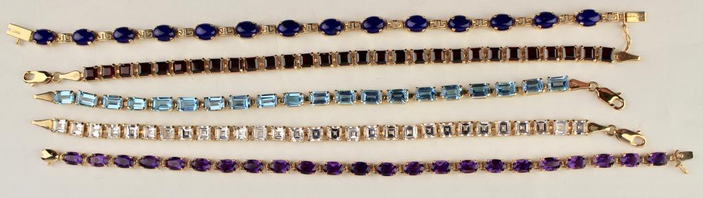 Five 14K Gold and Gemstone Bracelets: blue topaz, amethyst, garnet, lapis, and white topaz. 36.9 grams. 7-7.5" long.