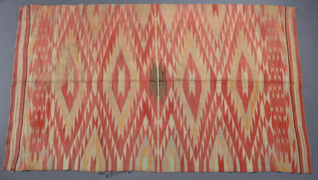 Southwest Native American Serape: (Navajo) c. 1910-20, thin, tight weave, with busy zigzag field, brown medallion center, colors of red, cream, yellow, neutral, in extraordinary condition for age, 88" x 52".