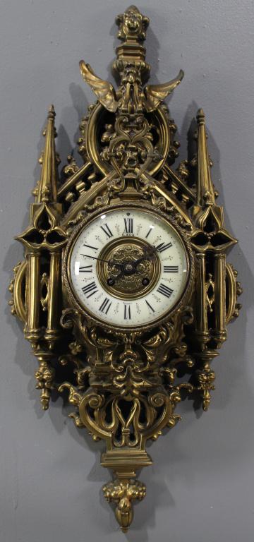 French Bronze Gothic Wall Clock: porcelain face with Roman numerals, reads "Lava" and "Nancy", very ornate with griffin, chimes on hour, runs great, 27" x 12" x 4".