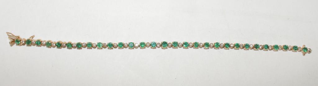 14K Emerald and Diamond Bracelet: 28 diamonds, 28 emeralds, set in 14k yellow gold, 7" long. 2.90 ctw, Emeralds, tone 5, sat 4. Diamonds .58 tcw, 9.1 grams tw, 7" long.