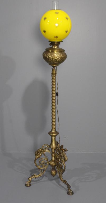 R. Holliings and Company Piano Lamp: Boston, MA. ornate, polished brass, four fancy feet, spring tension adjustable height, electrified Duplex burner, yellow blown glass decorated shade and chimney, signed, good condition, 62" adjust to 