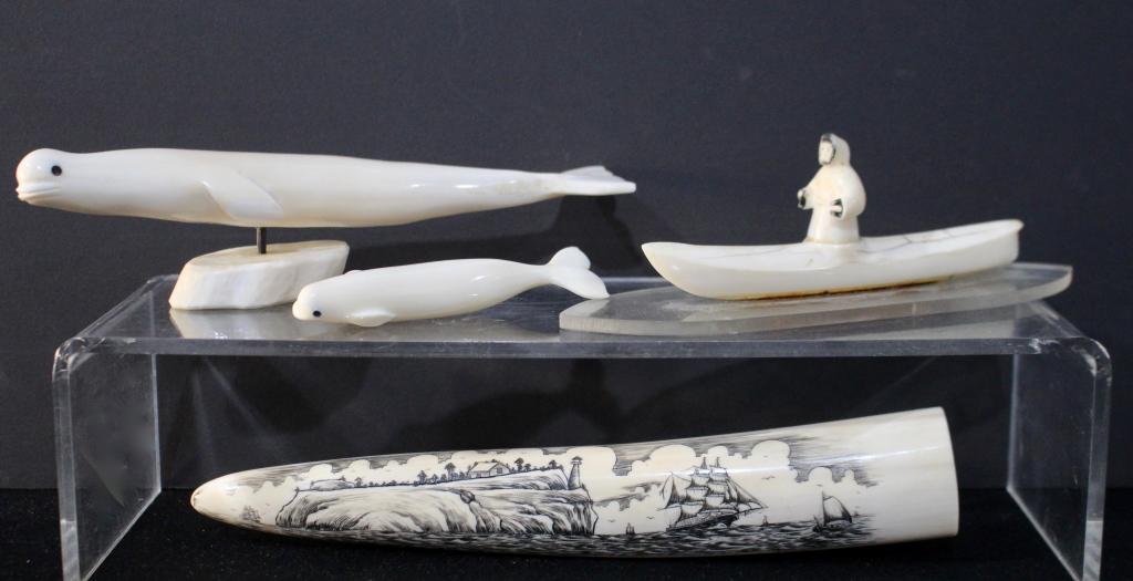 Four Inuit Carved Items: 10" carved walrus tusk with scrimshaw on 2 sides, artist signed but unreadable, a 4.25" carved whale, a 10.25" carved whale on stand signed "Lester" and " Eskimo in a kayak, all in good condition.