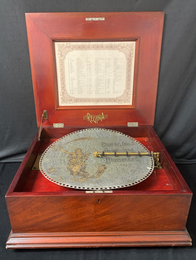 Antique Regina Music Box 1890: Antique Regina Music Box 1890's. It plays music from the 11 metal records that come with the music box. It measures 8.5" x 20.5" x 18.5" and weighs 40 lbs. Overall condition is good.