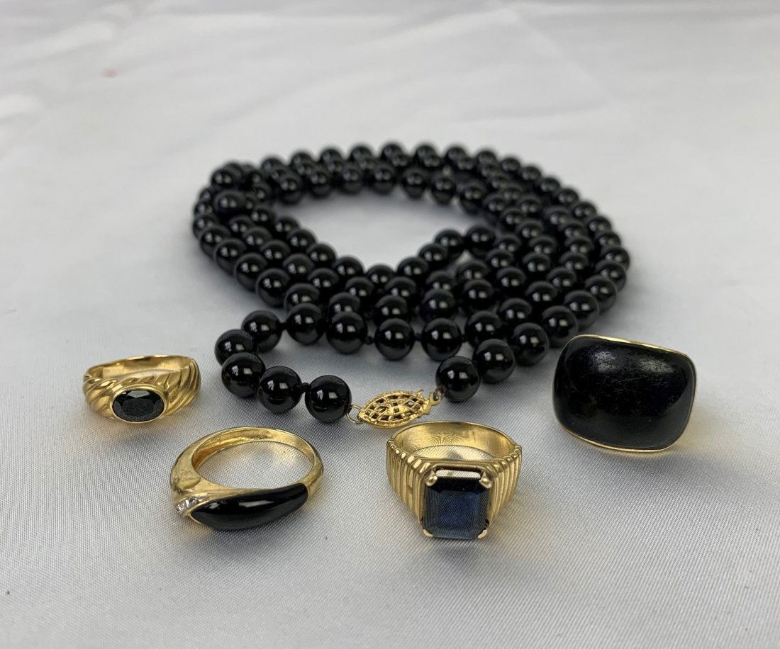 Lot of 14k yellow Gold & Onyx 1 necklace and 4 rings.: Lot of 14k yellow Gold & Onyx 1 necklace and 4 rings. 1 Onyx necklace 18 1/2". 4 Onyx & 14k gold rings sizes 6 1/2, 7, 7 1/2 & 8. In good condition.
