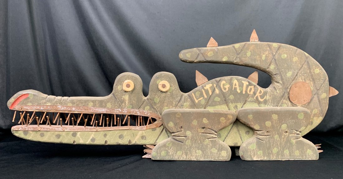 American Folk Art Alligator "Litigator": American Folk Art Alligator "Litigator". Wood with metal. Metal spikes and nails are sharp. Measures 32" x 13" x 3". Good condition. Weighs 6 lbs.