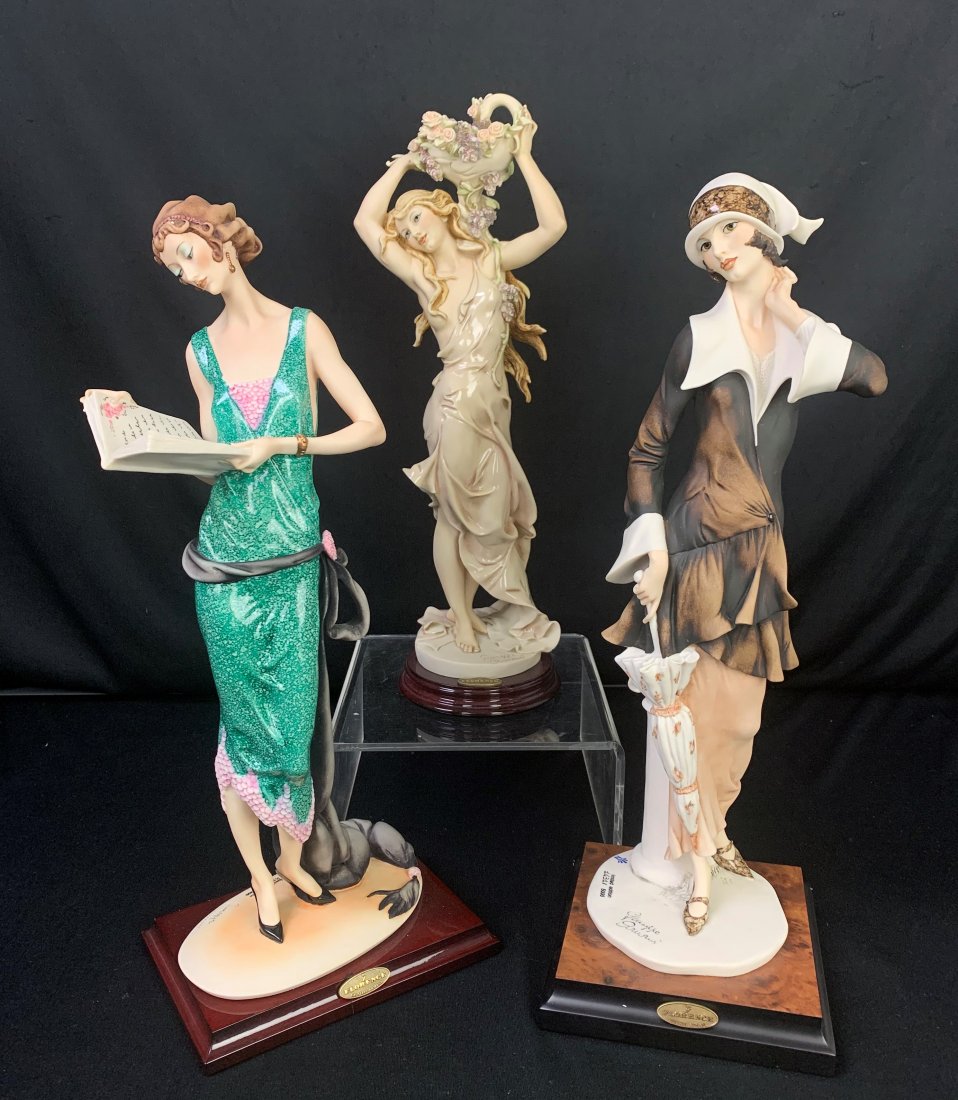 3 Giuseppe Armani Figurines-Book, Umbrella & Flowers: 3 Giuseppe Armani Figurines. Dama con Libro "Lady with Book" measures 18" x 7" x 6 1/2". Dama con Ombrello "Lady with Umbrella" measures 18" x 6" x 4". Ragazza con cesto di Fiori Lilac and Roses "Girl