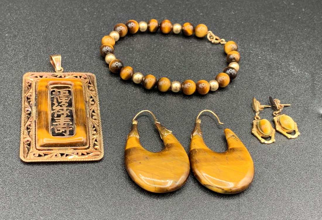 14K Gold & Tiger: 14K Gold & Tiger's Eye Jewelry Lot. Bracelet measures 7" long. Two pairs of earrings, hoops are 2" long and one is missing the back post. The post earrings are 3/4" long. Pendant is 2" x 1 1/4". Overa