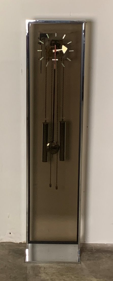 Howard Miller Chrome Grandfather Clock by G. Nelson: Howard Miller Chrome Grandfather Clock by George Nelson. Clock measures 56" x 13" x 5". Overall condition is good.