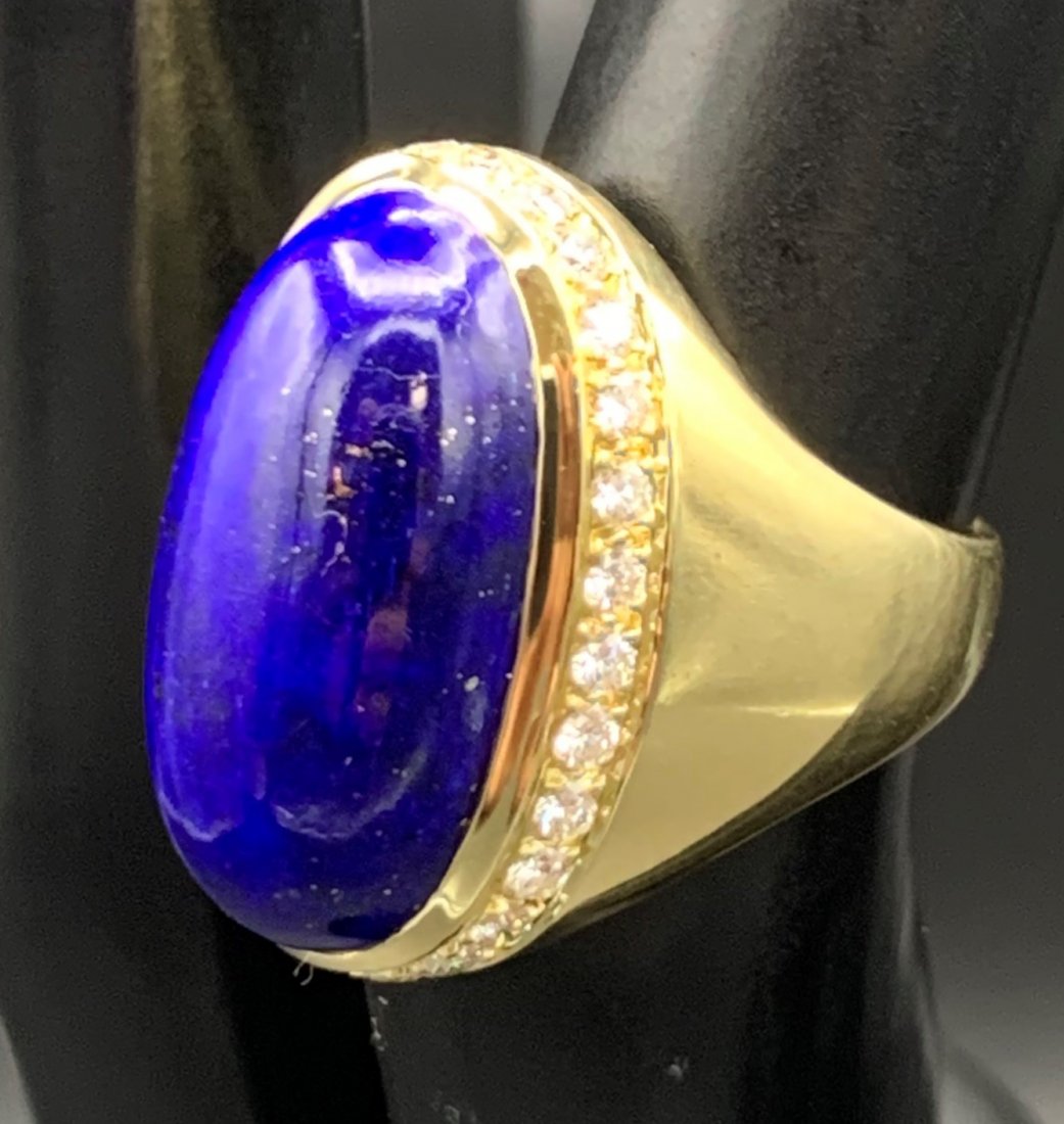 18K Gold Lapis Lazuli Ring w/Diamond Halo-Gumps: 18K Gold Vintage Lapis Lazuli Ring w/Diamond Halo. This ring was sold by Gumps Jewelry. Lapis is 21 x 12 mm. 28 1.7 mm round brilliant diamonds, .02 ct. each. Approximately 12.7 g. rings size is 5 3/4