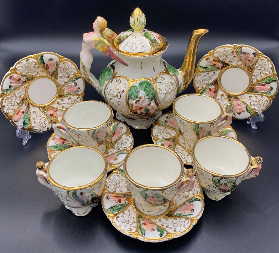 Capodimonte Porcelain Tea Service 11 Pcs.: Capodimonte Porcelain Tea Service. Eleven pieces of Capodimonte Porcelain. Teapot H- 10" x W- 6 1/2" x D- 10" , 5 saucers 6" & 5 cups 3". One cup has visible sign of wear on handle. In good condition.