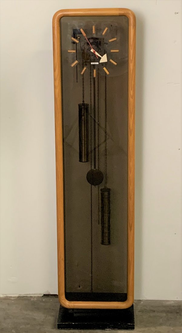 Howard Miller Grandfather Clock By George Nelson: Howard Miller Grandfather Clock By George Nelson. Mid century wood framed grandfather clock. It stands 56 1/2" tall, 14" wide and 5" deep. Overall condition is good.