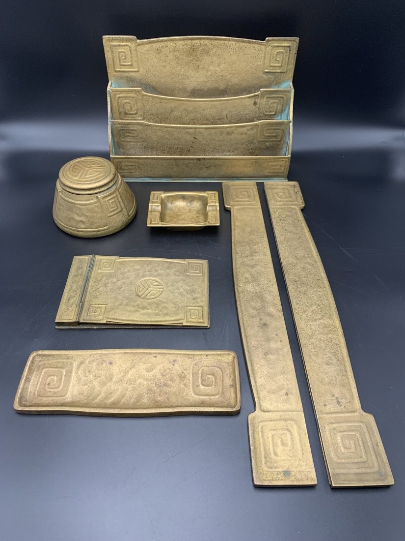 7 pcs Tiffany Studios NY Bronze Desk Set: 7 pcs Tiffany Studios New York Bronze Desk Set. Tiffany Studio desk set 7 pcs total. (1) pair of blotter end #1110 measure 19 1/4" long, (1) letter & paper desk rack #1116 measure H- 8" X W- 12" X D- 