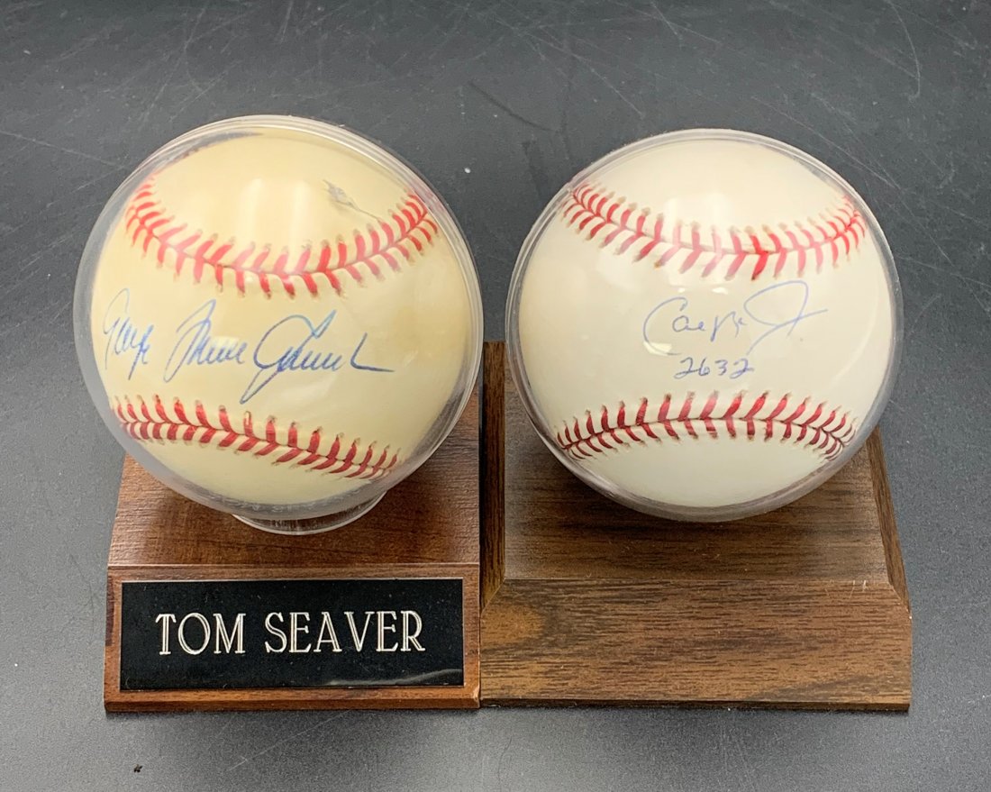2 Signed Baseballs- Tom Seaver & Cal Ripkin Jr, 2632: 2 Signed Baseballs- Tom Seaver & Cal Ripkin Jr, 2632 consecutive Games. Both signed baseballs come in a plastic case mounted on a wood base. Tom Seaver's has a name plate. All Baseball items in this a