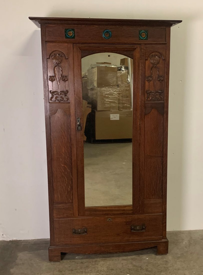 Scottish Art & Crats Oak Armoire with Tudric Rose Tiles: Scottish art & crats oak armoire with tudric rose Tiles, hand carved front panels, single bottom drawer, original hardware & beveled mirror. Armoire measures 81" tall x 40 1/2' wide x 18" deep. Inside